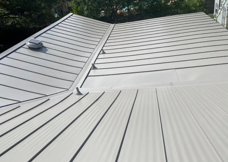 Solar attic fan installed on a metal roof for Roof Ventilation in Watertown